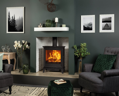 A Stovax wood-burning stove in a green living room