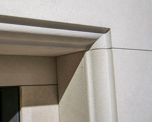 Detail of a carved limestone fireplace surround