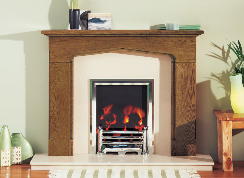 A limestone fireplace with a gas fire